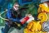 Diver cleaning LEGO model underwater