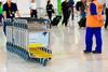 A row of luggage carts at an airport