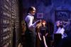 An actor with guests at the Peaky Blinders Underworld experience
