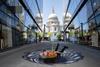 A man lies over an art installation of a vortex in front of St Paul's Cathedral