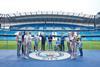 A group who are pitchside at the Etihad Stadium tour in Manchester