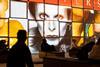 People sat in front of a screen depicting David Bowie's face