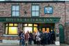 Members of the New Meridian Association outside the Rovers Return pub at the Coronation Street experience