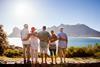 A group of friends look out over the sea during a holiday