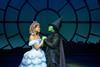 Lucy St. Louis (who plays Glinda) and Alexia Khadime (who plays Elphaba) embrace on stage.