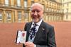 Graham Yandell with his MBE outside Buckingham Palace