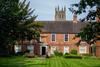 Old red brick building with large gardens