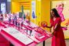 A woman looks at the We Go Way Back exhibition, touching different objects