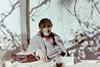 Agatha Christie sat at a table beneath a tree
