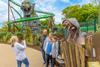 Woman taking a photo of a man and three children at Chessington World of Adventures Resort's new World of Jumanji themed land