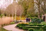 Two people exploring Wakehurst Winter Garden