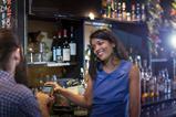 Customer paying by credit card machine in a pub