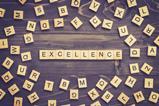 Excellence word wood block on table