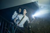 Couple going down stairs with torch and baseball bat