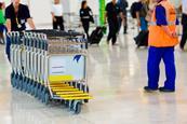 A row of luggage carts at an airport