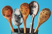 wooden and metal spoons with illustrated faces