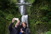 Couple taking selfie at Multnomah Falls, Oregon, USA