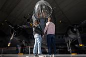 A couple stood in front of a plane