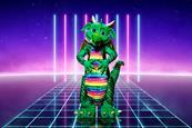 A promo shot of the Masked Singer featuring a green dragon costume