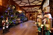 Inside of Hever Castle at Christmas decorated with colourful trees and nutcrackers