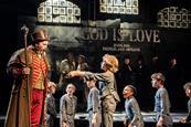 Oliver asks Mr Bumble for more gruel in the West End production of Oliver!