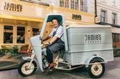 Jamie Oliver driving a scooter outside Jamie's Italian restaurant in the West End