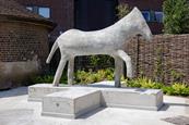 A concrete sculpture of a horse