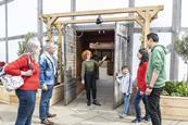 A group have a tour of Shakespeare's Globe