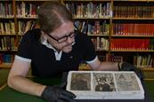 Three small drawings of the Bayeux Tapestry being looked at by a man in gloves