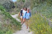 A group walking along sand in Dunkirk, France