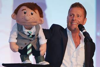 Ventriloquist Paul Zerdin with his puppet Sam on stage