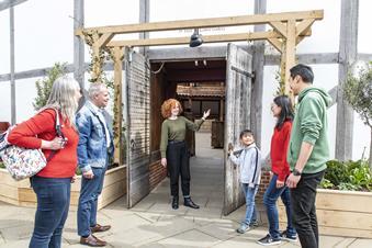 A group have a tour of Shakespeare's Globe