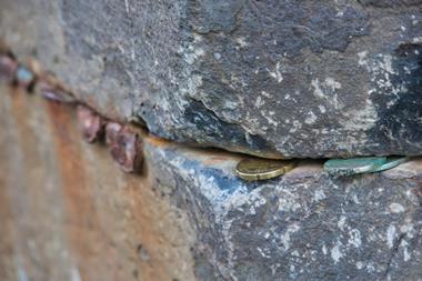 Coins jammed in Giants Causeway, Northern Ireland