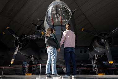 A couple stood in front of a plane