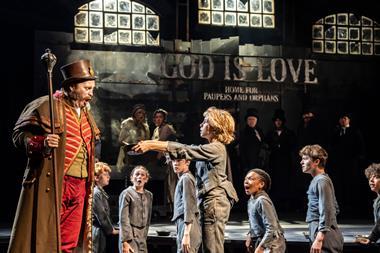 Oliver asks Mr Bumble for more gruel in the West End production of Oliver!