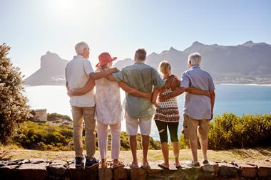 Group looking over the ocean and mountain range