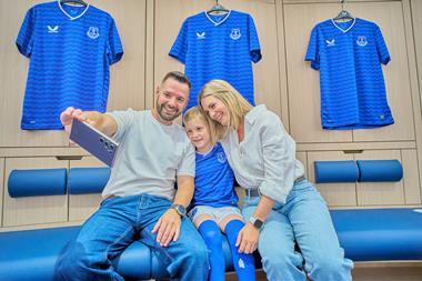 A family take a selfie during an Everton Football Club Stadium Tour