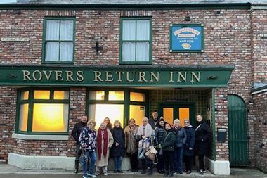 Members of the New Meridian Association outside the Rovers Return pub at the Coronation Street experience