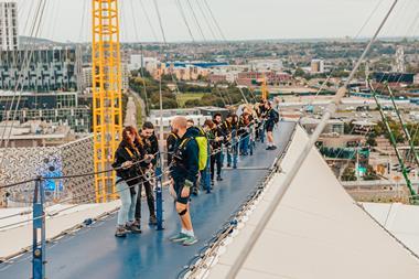 A group climbing on the roof at Up at The O2