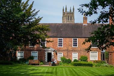 Old red brick building with large gardens