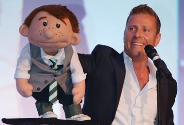 Ventriloquist Paul Zerdin with his puppet Sam on stage