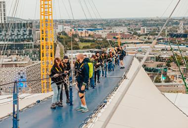 A group climbing on the roof at Up at The O2