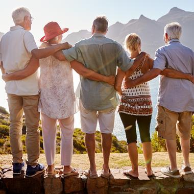 Group looking over the ocean and mountain range