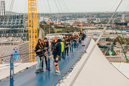 A group climbing on the roof at Up at The O2