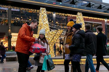 A group of shoppers looking pleased with their purchases while shopping in Lincoln