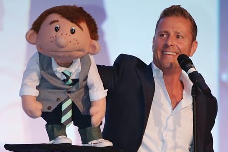 Ventriloquist Paul Zerdin with his puppet Sam on stage