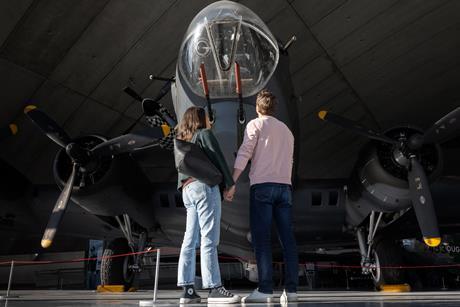 A couple stood in front of a plane