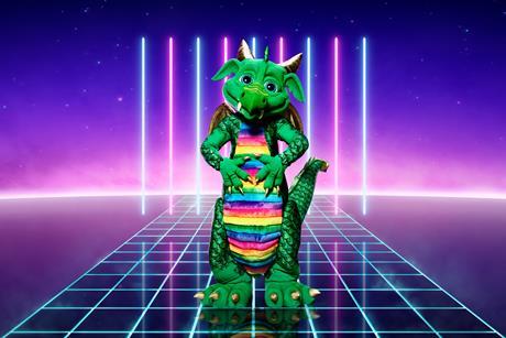 A promo shot of the Masked Singer featuring a green dragon costume