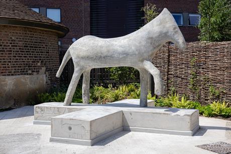 A concrete sculpture of a horse