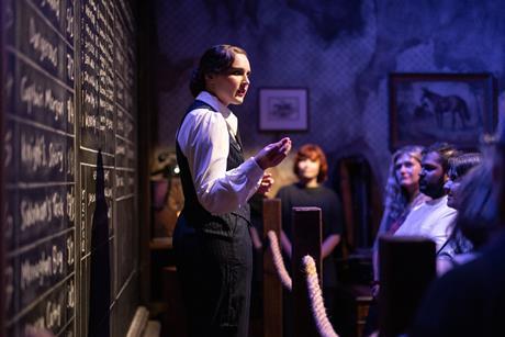 An actor with guests at the Peaky Blinders Underworld experience